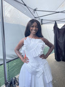 Model backstage at Marin Fashion Night 2026 in a sculptural white pleated Sphairistike tennis couture dress by Melanie Friedman.