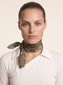Caddie Scarf in Fairway Baroque print styled as a neck scarf with a side knot. Luxury olive green square scarf for women with signature golf-inspired print. Olive green women's golf scarf with custom baroque golf club print. Crossover Golf, luxury womens golf apparel. Chic golf clothes for women. Women golfwear cool. 