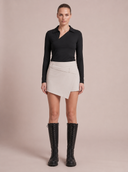 Crossover Golf Ace Asymmetric Skort, tailored women’s golf skort with asymmetric front and sculpting fit, made from Japanese Paper Nylon performance fabric, styled as a chic golf outfit for modern country club style on and off the course. Water resistant skort. Water repellant skort.
