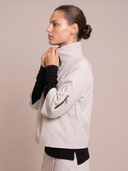 Crossover Golf Condor Cropped Windbreaker, tailored women’s golf jacket with cropped silhouette and Japanese Paper Nylon performance fabric, styled as a chic golf outfit for modern country club style on and off the course. Chic womens golf apparel. Best womens golf apparel. Cool womens golf clothes.