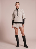 Crossover Golf Condor Cropped Windbreaker, tailored women’s golf jacket with cropped silhouette and Japanese Paper Nylon performance fabric, styled as a chic golf outfit for modern country club style on and off the course. Chic womens golf apparel. Best womens golf apparel. Cool womens golf clothes.