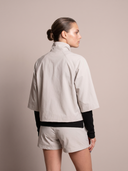 Crossover Golf Condor Cropped Windbreaker, tailored women’s golf jacket with cropped silhouette and Japanese Paper Nylon performance fabric, styled as a chic golf outfit for modern country club style on and off the course. Chic womens golf apparel. Best womens golf apparel. Cool womens golf clothes.