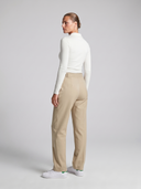 High-waisted women’s golf trousers with tailored straight-leg fit and 4-way stretch, chic golf outfit designed for on and off the course.Water repellant women's golf pant. Machine washable women's golf pant. Flattering womens golf pant. Cool women's golf pant. Crossover Golf by Melanie Friedman. Golf fashion house. golf high fashion. golf chic clothes for women